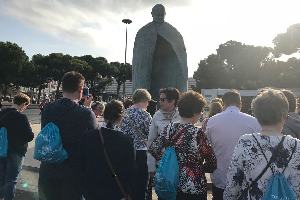 Pilgrim group at Statue of Pope John Paul II, Termini Station, Rome
